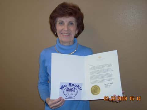 Marilyn holding her Rare Disease Day Proclamation